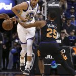 Golden State Warriors guard Stephen Curry (30) is fouled by Phoenix Suns forward Mikal Bridges (25) during the first half of an NBA basketball game Friday, Feb. 8, 2019, in Phoenix. (AP Photo/Ross D. Franklin)