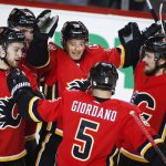 Calgary Flames' Derek Ryan (10) celebrates his goal with teammates during first period NHL hockey action against the Arizona Coyotes in  Calgary, Alberta, Monday, Feb. 18, 2019. (Jeff McIntosh/The Canadian Press via AP)