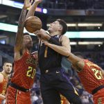 Phoenix Suns guard Devin Booker (1) is fouled by Atlanta Hawks guard Kent Bazemore, right, as Hawks forward John Collins (20) defends during the first half of an NBA basketball game Saturday, Feb. 2, 2019, in Phoenix. (AP Photo/Ross D. Franklin)