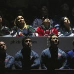The Arizona Coyotes team and staff along with fans look up at the scoreboard as the team honors Shane Doan during his jersey retirement ceremony prior to an NHL hockey game against the Winnipeg Jets Sunday, Feb. 24, 2019, in Glendale, Ariz. (AP Photo/Ross D. Franklin)
