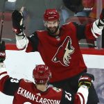 Arizona Coyotes center Brad Richardson (15) smiles as he celebrates his hat trick against the Vancouver Canucks with defenseman Oliver Ekman-Larsson (23) during the second period of an NHL hockey game Thursday, Feb. 28, 2019, in Glendale, Ariz. (AP Photo/Ross D. Franklin)