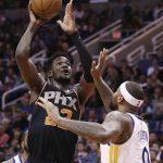 Phoenix Suns center Deandre Ayton, left, shoots over Golden State Warriors center DeMarcus Cousins during the second half of an NBA basketball game Friday, Feb. 8, 2019, in Phoenix. The Warriors defeated the Suns 117-107. (AP Photo/Ross D. Franklin)