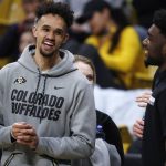 San Antonio spurs guard Derrick White, left, jokes with his former Colorado teammate Namon Wright before the second half of an NCAA college basketball game between Arizona State and Colorado on Wednesday, Feb. 13, 2019, in Boulder, Colo. Colorado won 77-73. (AP Photo/David Zalubowski)