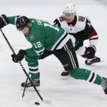 Dallas Stars center Radek Faksa (12) skates for the puck against Arizona Coyotes right wing Richard Panik (14) during the first period of an NHL hockey game in Dallas, Monday, Feb. 4, 2019. (AP Photo/LM Otero)