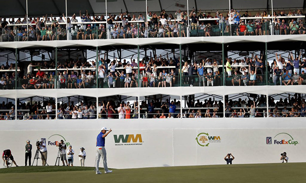 The crowd cheers after Rickie Fowler made his birdie putt on the 16th green during the second round...