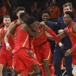 Arizona's Brandon Randolph, left, and Brandon Williams, right, celebrate with Devonaire Doutrive, center, after Doutrive scored in the final second of the game, securing the win over Oregon State during an NCAA college basketball game in Corvallis, Ore., Thursday, Feb. 28, 2019. Arizona won 74-72. (AP Photo/Amanda Loman)