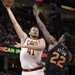 Cleveland Cavaliers' Ante Zizic (41), from Croatia, shoots over Phoenix Suns' Deandre Ayton (22) in the first half of an NBA basketball game, Thursday, Feb. 21, 2019, in Cleveland. (AP Photo/Tony Dejak)