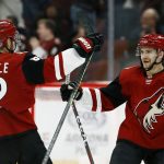 Arizona Coyotes center Vinnie Hinostroza, right, celebrates his goal against the Florida Panthers with Coyotes defenseman Jordan Oesterle (82) during the shootout in an NHL hockey game Tuesday, Feb. 26, 2019, in Glendale, Ariz. The Coyotes won 4-3. (AP Photo/Ross D. Franklin)