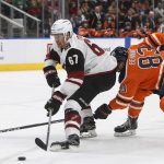 Arizona Coyotes' Lawson Crouse (67) is chased by Edmonton Oilers' Matthew Benning (83) during the first period of an NHL hockey game Tuesday, Feb. 19, 2019, in Edmonton, Alberta. (Jason Franson/The Canadian Press via AP)