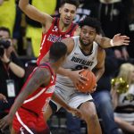 Colorado forward Evan Battey, center, gets trapped with the ball between Arizona forward Ira Lee, front, and center Chase Jeter in the first half of an NCAA college basketball game Sunday, Feb. 17, 2019, in Boulder, Colo. (AP Photo/David Zalubowski)