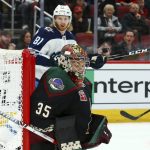 Arizona Coyotes goaltender Darcy Kuemper (35) gives up a goal to Winnipeg Jets' Patrik Laine as Jets left wing Kyle Connor (81) looks on during the first period of an NHL hockey game Sunday, Feb. 24, 2019, in Glendale, Ariz. (AP Photo/Ross D. Franklin)
