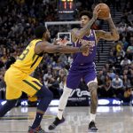 Phoenix Suns' Kelly Oubre Jr., right, looks to pass the ball as Utah Jazz's Royce O'Neale defends during the first half of an NBA basketball game Wednesday, Feb. 6, 2019, in Salt Lake City. (AP Photo/Kim Raff)