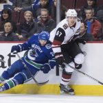 Vancouver Canucks' Loui Eriksson, left, of Sweden, and Arizona Coyotes' Lawson Crouse collide during the first period of an NHL hockey game Thursday, Feb. 21, 2019, in Vancouver, British Columbia. (Darryl Dyck/The Canadian Press via AP)