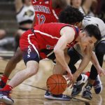 Arizona guard Alex Barcello, front, fights for control of a loose ball with Colorado guard Daylen Kountz in the first half of an NCAA college basketball game Sunday, Feb. 17, 2019, in Boulder, Colo. (AP Photo/David Zalubowski)