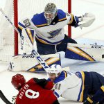 St. Louis Blues goaltender Jordan Binnington (50) makes a save on a shot by Arizona Coyotes center Clayton Keller (9) as Blues defenseman Robert Bortuzzo (41) and center Ryan O'Reilly (90) try to block the shot during the second period of an NHL hockey game Thursday, Feb. 14, 2019, in Glendale, Ariz. (AP Photo/Ross D. Franklin)