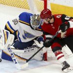 St. Louis Blues goaltender Jordan Binnington (50) makes a save on a shot by Arizona Coyotes right wing Conor Garland (83) during the first period of an NHL hockey game Thursday, Feb. 14, 2019, in Glendale, Ariz. (AP Photo/Ross D. Franklin)