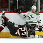 Dallas Stars right wing Brett Ritchie (25) sends Arizona Coyotes defenseman Oliver Ekman-Larsson (23) to the ice during the first period of an NHL hockey game Saturday, Feb. 9, 2019, in Glendale, Ariz. (AP Photo/Ross D. Franklin)