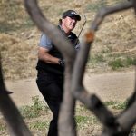 Phil Mickelson watches his shot from desert area off the ninth fairway during the second round of the Phoenix Open PGA golf tournament, Friday, Feb. 1, 2019, in Scottsdale, Ariz. (AP Photo/Matt York)