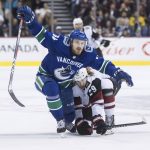 Vancouver Canucks' Tyler Motte, left, and Arizona Coyotes' Mario Kempe, of Sweden, collide during the first period of an NHL hockey game Thursday, Feb. 21, 2019, in Vancouver, British Columbia. (Darryl Dyck/The Canadian Press via AP)
