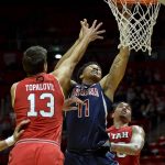 Arizona forward Ira Lee (11) attempts a shot between Utah forwards Novak Topalovic, left, and Timmy Allen, right, during the first half of an NCAA college basketball game Thursday, Feb. 14, 2019, in Salt Lake City. (AP Photo/Alex Goodlett)