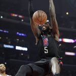 Los Angeles Clippers forward Montrezl Harrell dunks as Phoenix Suns forward Mikal Bridges watches during the first half of an NBA basketball game Wednesday, Feb. 13, 2019, in Los Angeles. (AP Photo/Mark J. Terrill)