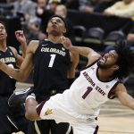 Arizona State guard Remy Martin, right, tumbles while driving to the rim for a basket past Colorado guards Shane Gatling, left, and Tyler Bey in the first half of an NCAA college basketball game Wednesday, Feb. 13, 2019, in Boulder, Colo. (AP Photo/David Zalubowski)