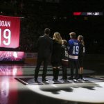From left to right Shane Doan, left, wife Andrea Doan, children Carson Doan, Josh Doan, and Karys Doan, watch as the Arizona Coyotes retire Shane's jersey during a ceremony prior to an NHL hockey game against the Winnipeg Jets Sunday, Feb. 24, 2019, in Glendale, Ariz. (AP Photo/Ross D. Franklin)