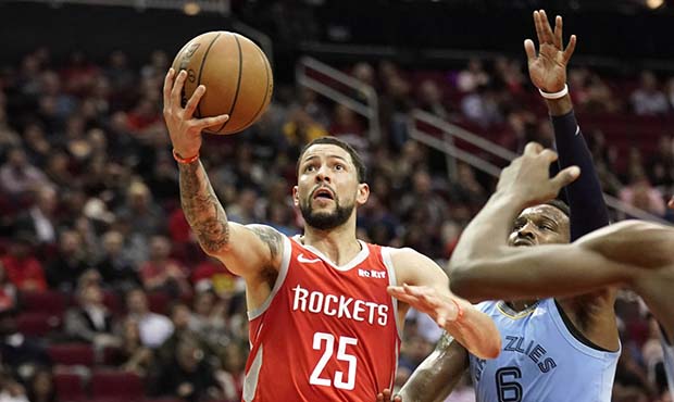 Houston Rockets' Austin Rivers (25) goes up for a shot as Memphis Grizzlies' Shelvin Mack (6) defen...