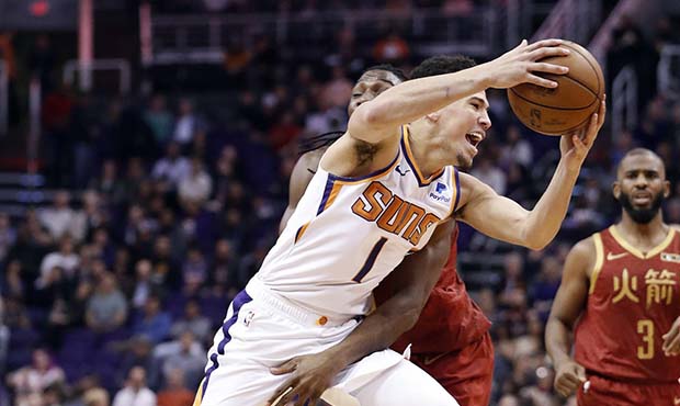 Phoenix Suns guard Devin Booker (1) is fouled by Houston Rockets forward Kenneth Faried during the ...