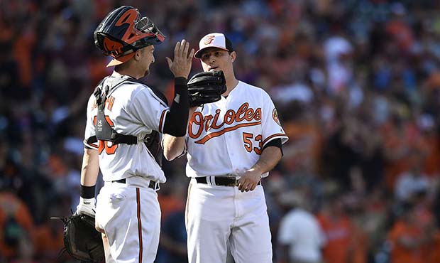 Baltimore Orioles catcher, Caleb Joseph, left, and pitcher Zach Britton celebrate their win over th...