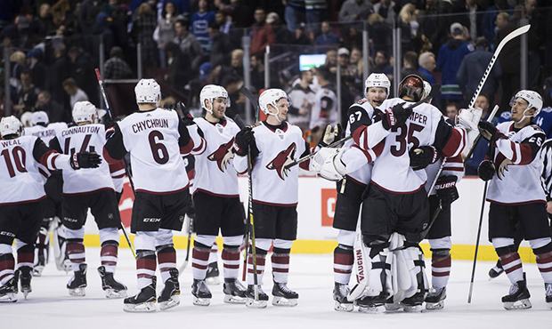 Arizona Coyotes' Lawson Crouse (67) and goalie Darcy Kuemper (35) celebrate after the Coyotes defea...