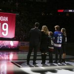 From left to right Shane Doan, left, wife Andrea Doan, children Carson Doan, Josh Doan, and Karys Doan, watch as the Arizona Coyotes retire Shane's jersey during a ceremony prior to an NHL hockey game against the Winnipeg Jets Sunday, Feb. 24, 2019, in Glendale, Ariz. (AP Photo/Ross D. Franklin)
