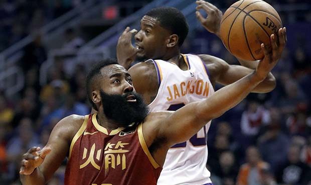 Houston Rockets guard James Harden (13) scores around Phoenix Suns forward Josh Jackson (20) during...