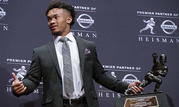 FILE - In this Dec. 8, 2018, file photo, Oklahoma quarterback Kyler Murray holds the Hesiman Trophy...