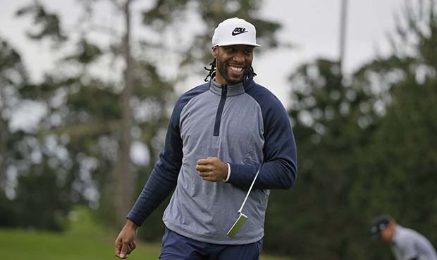 Larry Fitzgerald Jr. smiles before putting on the 10th green of the Spyglass Hill Golf Course durin...