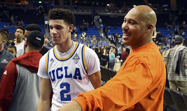 FILE - In this Nov. 20, 2016, file photo, UCLA's Lonzo Ball (2) walks by his father LaVar Ball, rig...