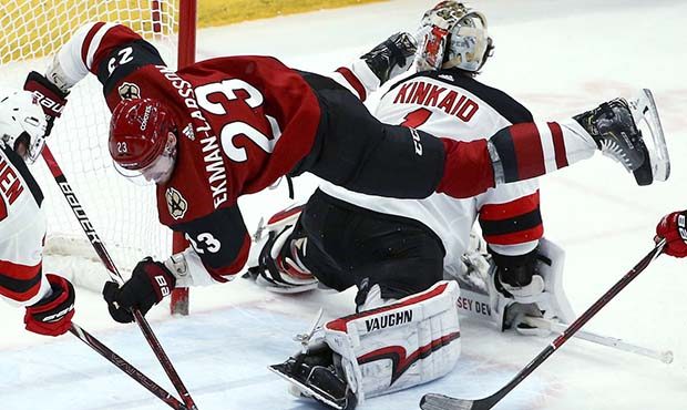 Arizona Coyotes defenseman Oliver Ekman-Larsson (23) tries to get a shot off as he flips over New J...