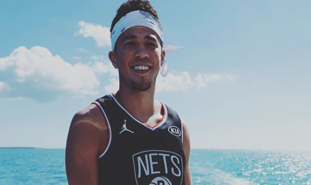 Fingers crossed: Devin Booker dons RFA-to-be D'Angelo Russell's jersey