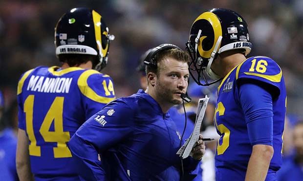 Los Angeles Rams head coach Sean McVay, center, speaks to Jared Goff (16) on the sideline during th...