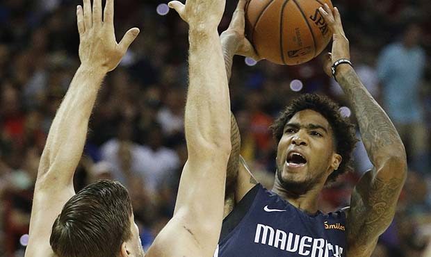 Dallas Mavericks' Ray Spalding, center, shoots over Phoenix Suns' Jack Cooley (45) during the first...
