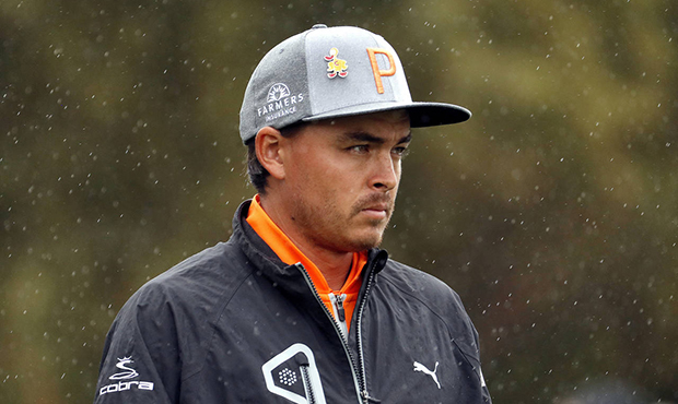 Rain falls as Rickie Fowler walks off the fifth tee box during the final round of the Phoenix Open ...