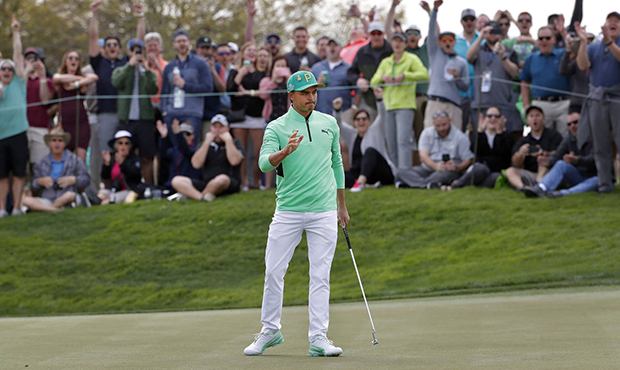 Rickie Fowler waves after making a birdie putt on the fifth green during the third round of the Pho...