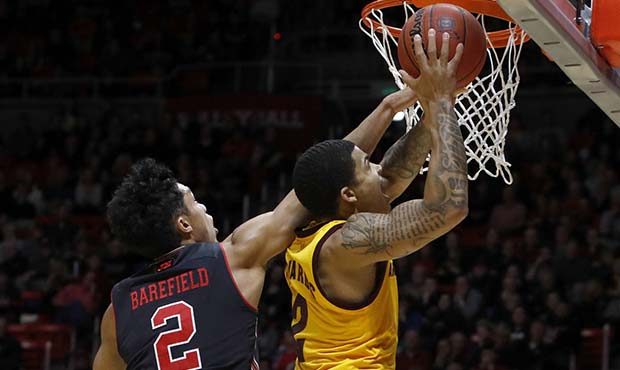 Arizona State's Rob Edwards, right, attempts a layup as Utah's Sedrick Barefield defends during the...