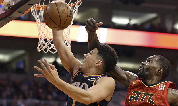 Phoenix Suns guard Devin Booker (1) has his shot blocked by Atlanta Hawks center Dewayne Dedmon (14...
