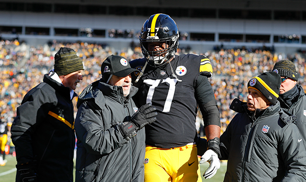 Marcus Gilbert #77 of the Pittsburgh Steelers is helped off the field by trainers against the Jacks...
