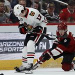 Arizona Coyotes center Clayton Keller (9) pokes the puck away from Chicago Blackhawks center Dylan Strome (17) during the first period of an NHL hockey game Tuesday, March 26, 2019, in Glendale, Ariz. (AP Photo/Ross D. Franklin)