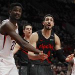 Phoenix Suns center Deandre Ayton, left, and Portland Trail Blazers center Enes Kanter, right, plead with a referee during the second half of an NBA basketball game in Portland, Ore., Saturday, March 9, 2019. Portland defeated Phoenix 127-120. (AP Photo/Steve Dipaola)