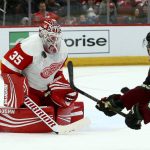 Detroit Red Wings goaltender Jimmy Howard (35) makes a save on a shot by Arizona Coyotes right wing Josh Archibald, right, during the second period of an NHL hockey game Saturday, March 2, 2019, in Glendale, Ariz. (AP Photo/Ross D. Franklin)