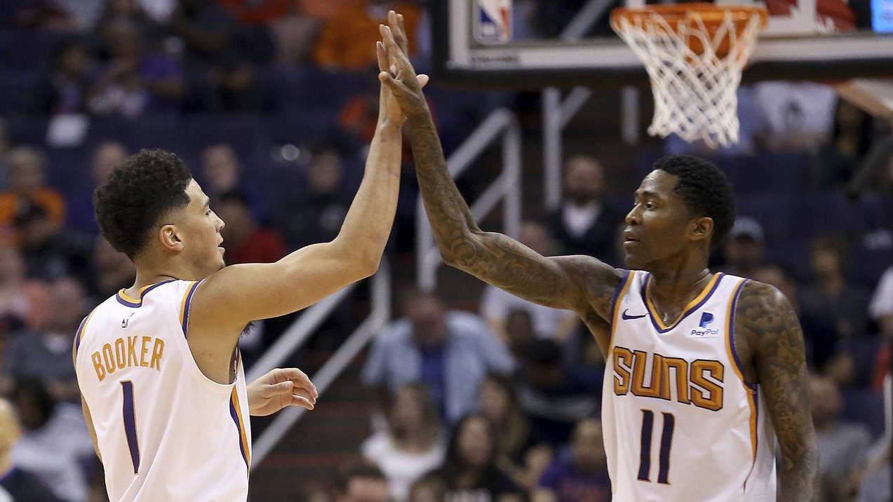 Phoenix Suns guard Devin Booker (1) celebrates his dunk against the Washington Wizards with guard J...