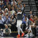 Utah Jazz guard Donovan Mitchell, center, celebrates a teammate's score against the Phoenix Suns during the second half of an NBA basketball game Monday, March 25, 2019, in Salt Lake City. (AP Photo/Rick Bowmer)
